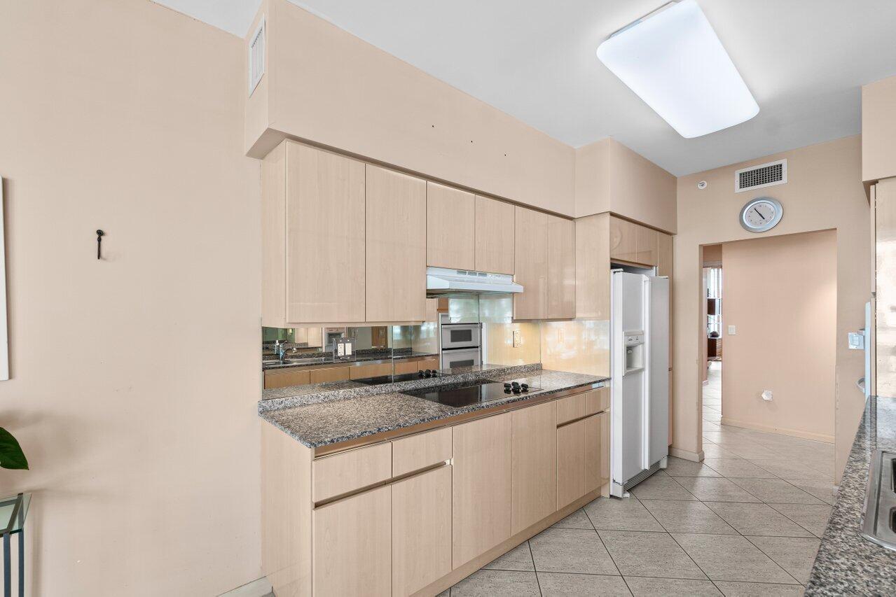 500 Southeast Mizner Boulevard, Unit A411 Boca Raton, FL 33432 - Photo 15 of 67 a kitchen with stainless steel appliances granite countertop a sink stove and cabinets