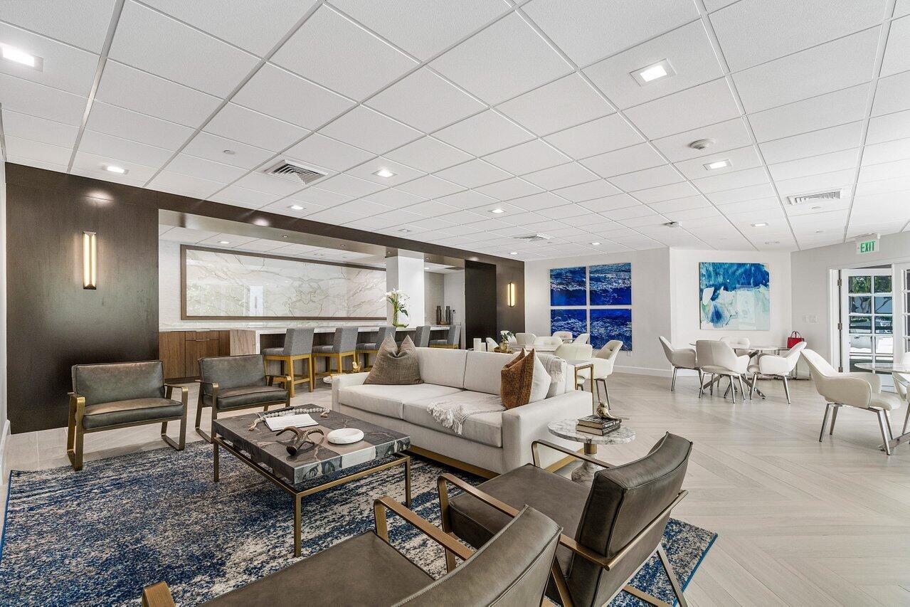 500 Southeast Mizner Boulevard, Unit A411 Boca Raton, FL 33432 - Photo 48 of 67 a living room with furniture a table and a flat screen tv