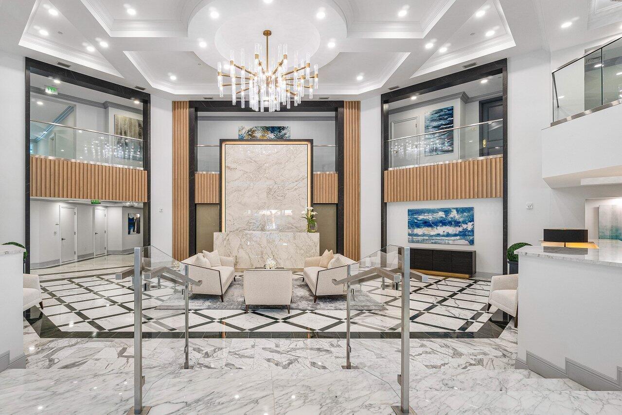 500 Southeast Mizner Boulevard, Unit A411 Boca Raton, FL 33432 - Photo 61 of 67 a living room with furniture a chandelier and a fireplace