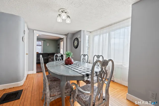 a view of a dining room with furniture and a window