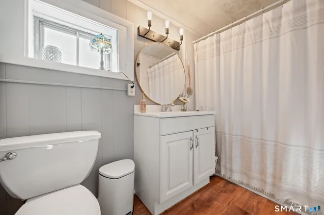 a white toilet sitting next to a bathroom sink