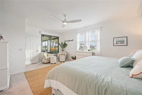 a spacious bedroom with a bed and a couch