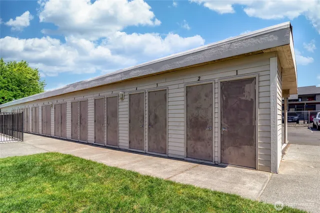 a view of a backyard with wooden fence