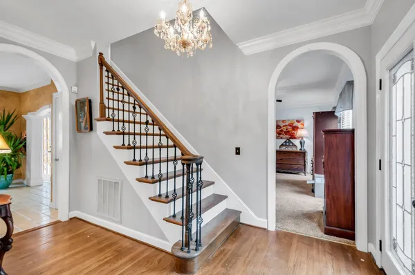 a view of entryway and hall with wooden floor