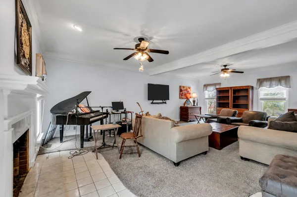 a living room with furniture fireplace and a flat screen tv
