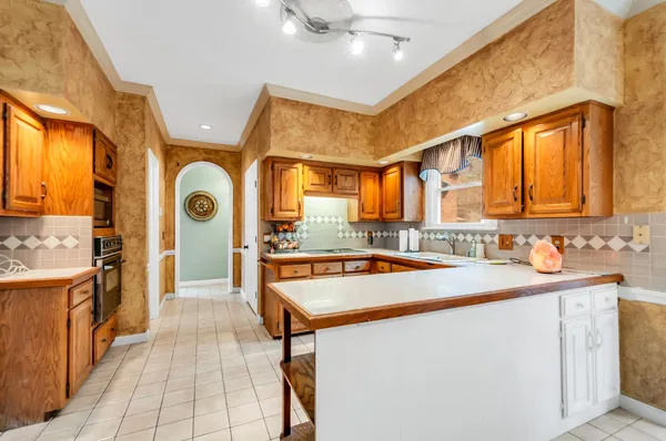 a kitchen with stainless steel appliances granite countertop a sink and cabinets