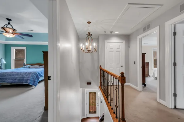 a bedroom with a bed and a chandelier