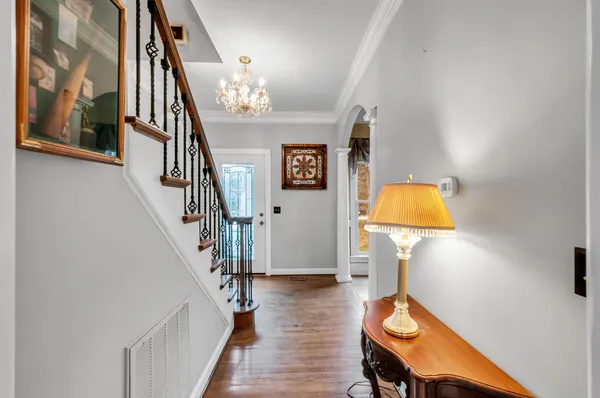 a view of entryway and hall with wooden floor