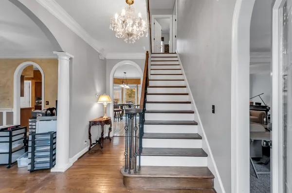 a view of entryway and hall with wooden floor