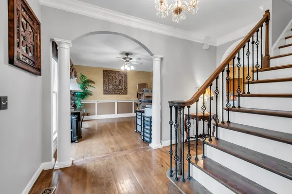 a view of entryway and hall with wooden floor