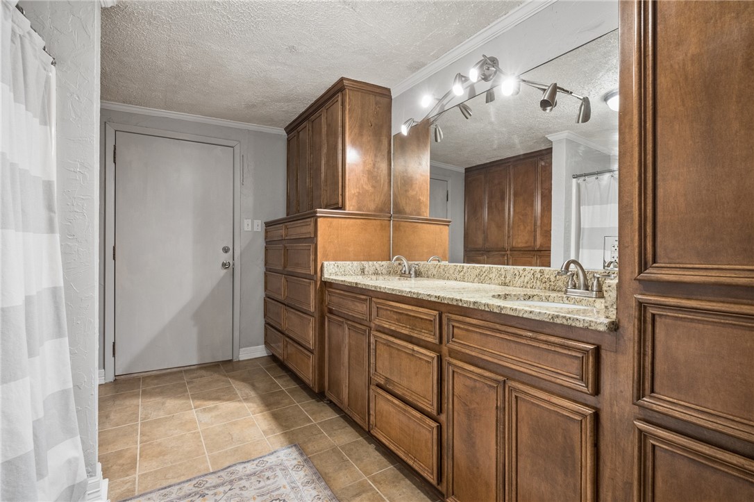 116 Sunset Drive Mathis, TX 78368 - Photo 11 of 32 a bathroom with a granite countertop sink and a mirror