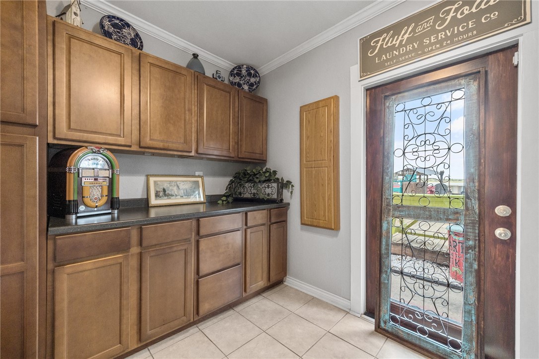 116 Sunset Drive Mathis, TX 78368 - Photo 13 of 32 a kitchen with stainless steel appliances granite countertop a refrigerator and a sink