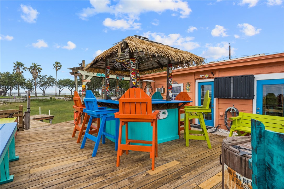 116 Sunset Drive Mathis, TX 78368 - Photo 15 of 32 a view of a chairs and table on the wooden deck