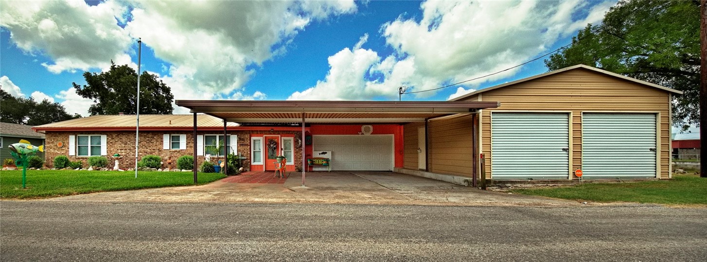 116 Sunset Drive Mathis, TX 78368 - Photo 25 of 32 a front view of a house with a yard and garage