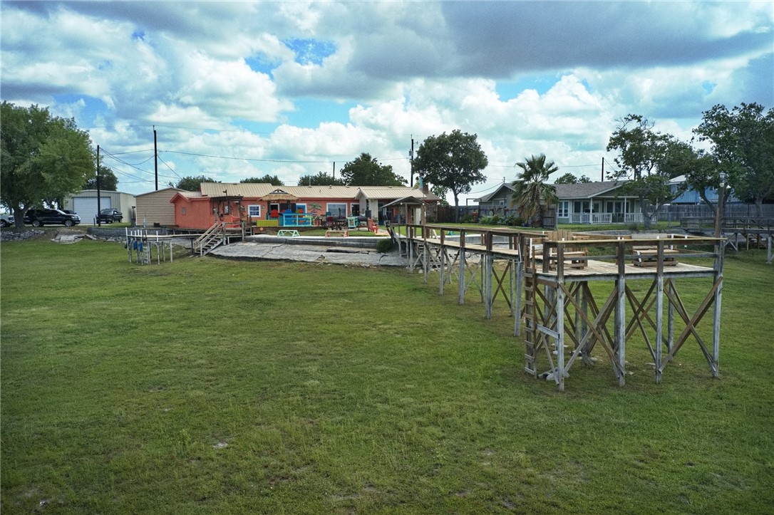 116 Sunset Drive Mathis, TX 78368 - Photo 28 of 32 a swimming pool with outdoor seating and yard