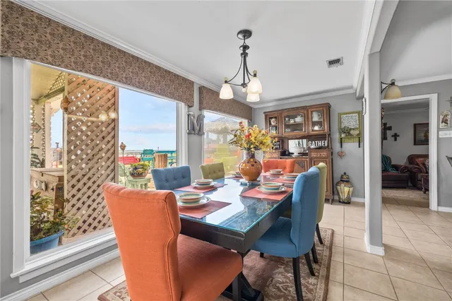 a dining room with wooden floor a chandelier a wooden table and chairs