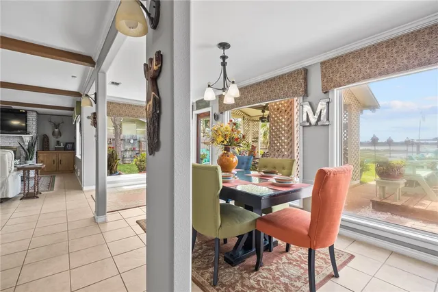 a dining room with furniture a chandelier and a rug