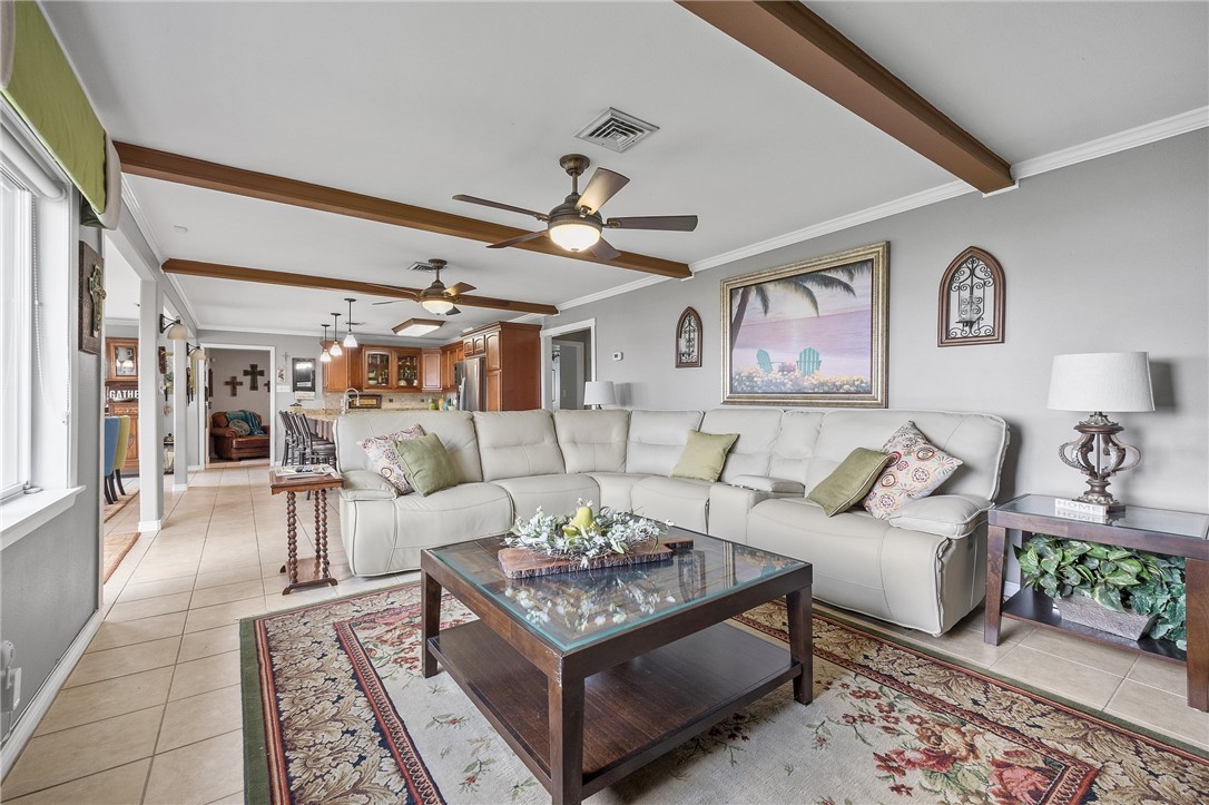 116 Sunset Drive Mathis, TX 78368 - Photo 9 of 32 a living room with furniture a rug and a table