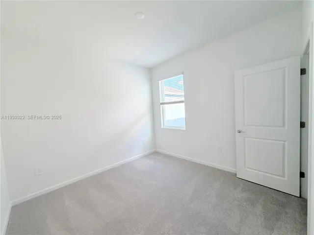 a white toilet sitting next to a shower