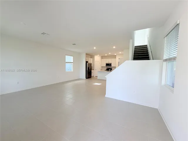 a view of a kitchen with furniture and windows