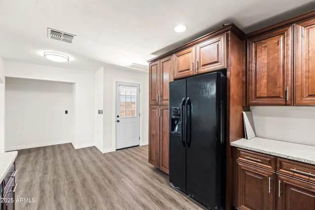 a kitchen with a refrigerator and window