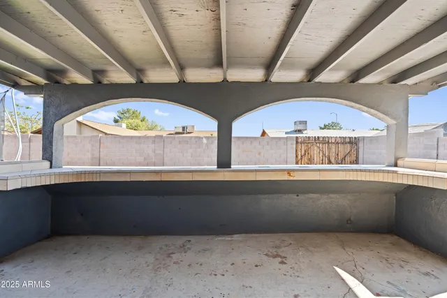 a view of room with two large window
