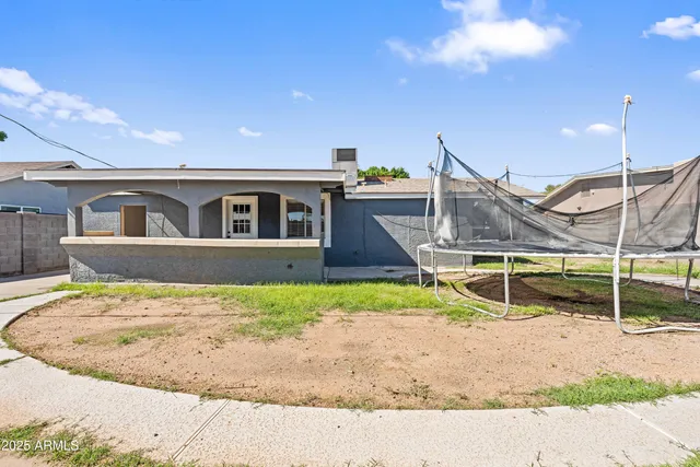 a view of a swimming pool with a yard