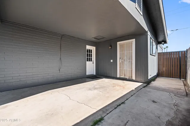 a view of backyard with wooden fence