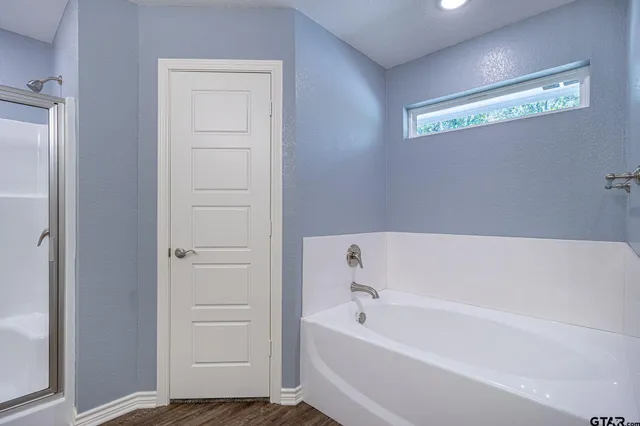 a bathroom with bathtub and shower