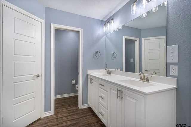 a bathroom with a double vanity sink and a mirror