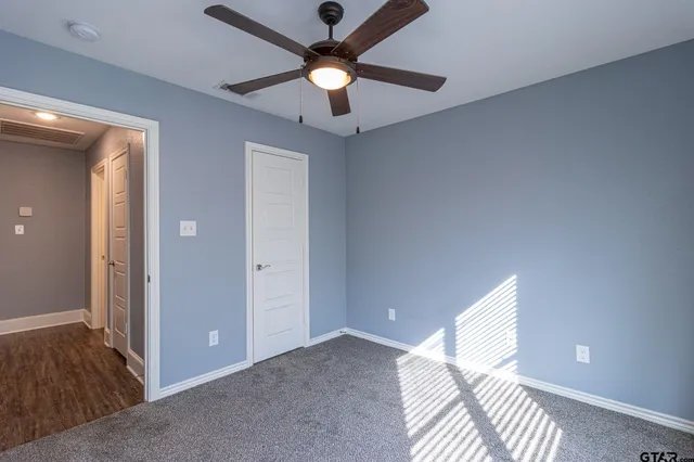 a view of workspace with hardwood floor and ceiling fan
