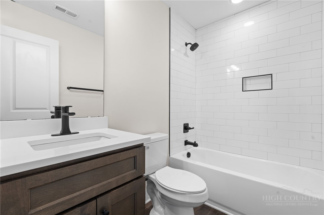 228 Stratford Lane Boone, NC 28607 - Photo 24 of 33 a bathroom with a sink a toilet and a bathtub