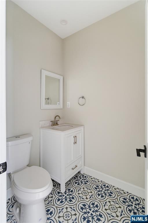 374 Valley Road River Edge, NJ 07661 - Photo 3 of 9 a bathroom with a toilet a sink and a window