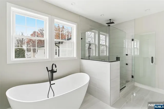 a white bath tub sitting next to a window