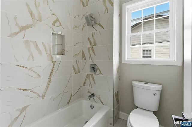 a bathroom with a toilet and a bathtub