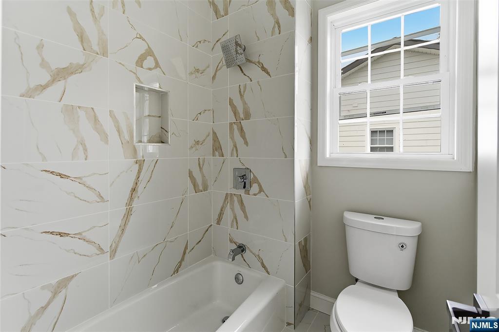 374 Valley Road River Edge, NJ 07661 - Photo 7 of 9 a bathroom with a toilet and a bathtub