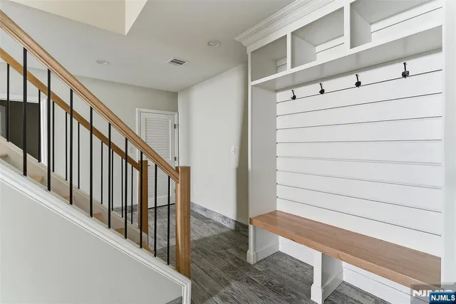 a view of staircase with lots of frames on wall