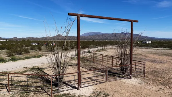 a view of a balcony with a floor to ceiling window and a tree