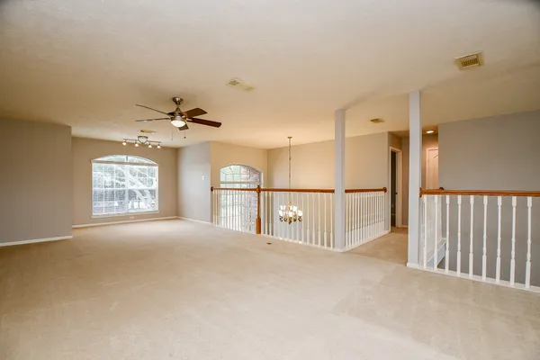 a view of entryway and hall with a chandelier fan