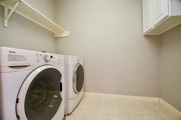 a front view of a house with a yard table and chairs