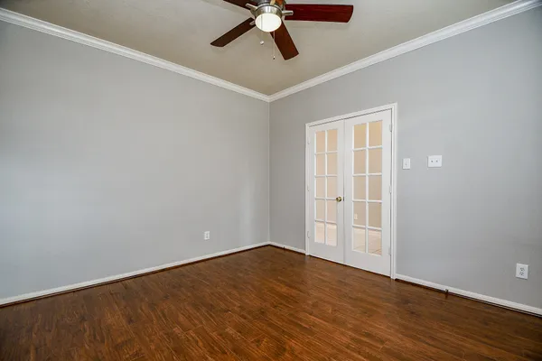 a view of empty room with wooden floor
