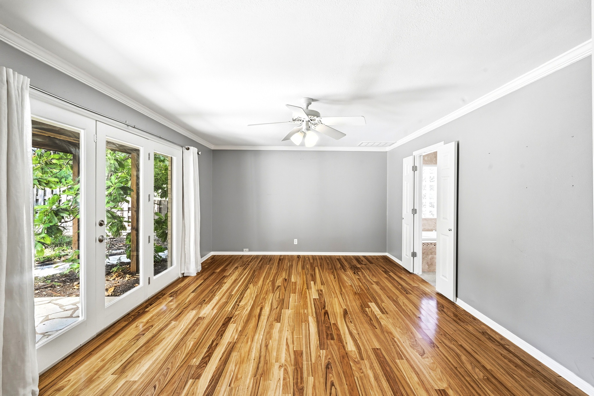 8608 Crest Ridge Circle Austin, TX 78750 - Photo 19 of 38 Rich hardwood floors complement garden views through French doors in this serene room.