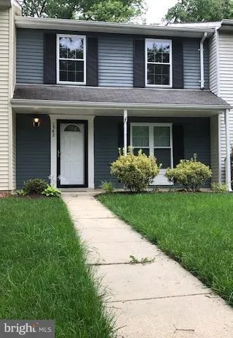 a front view of a house with a garden and plants
