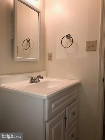 a bathroom with a sink and mirror