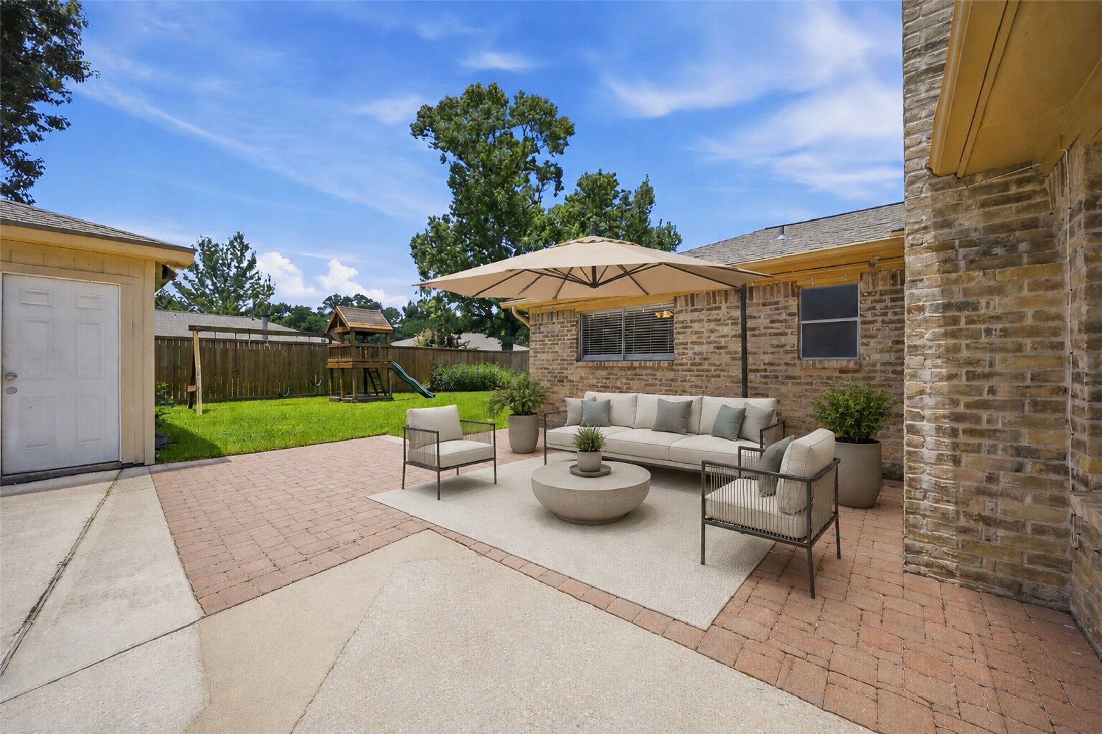 24015 Spring Mill Lane Spring, TX 77373 - Photo 5 of 49 Spacious covered patio creates the perfect setting for outdoor dining and gatherings. This photo is virtually staged.