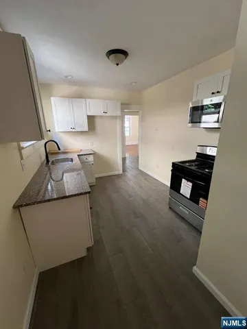 a kitchen that has a sink and a stove in it