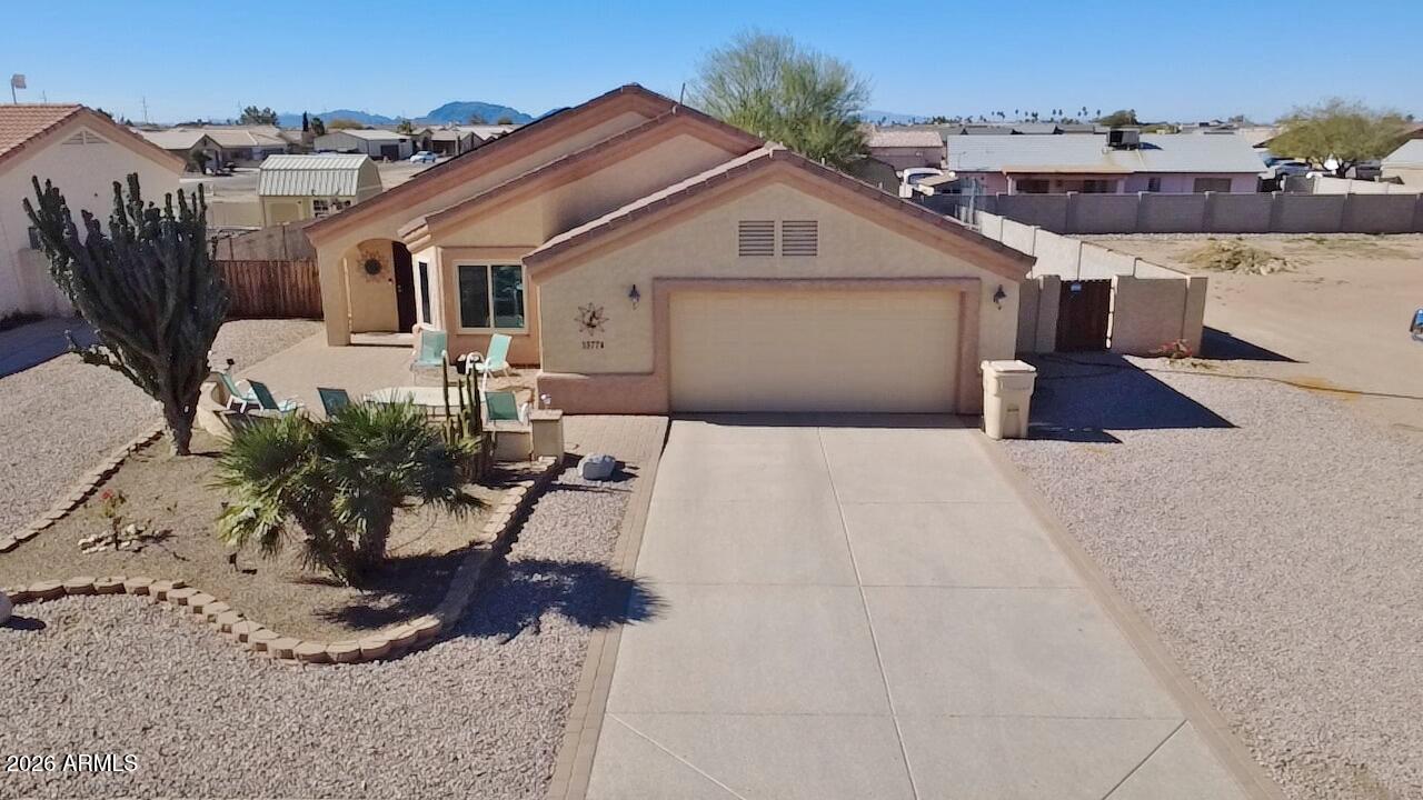 a view of a house with a yard and sitting area