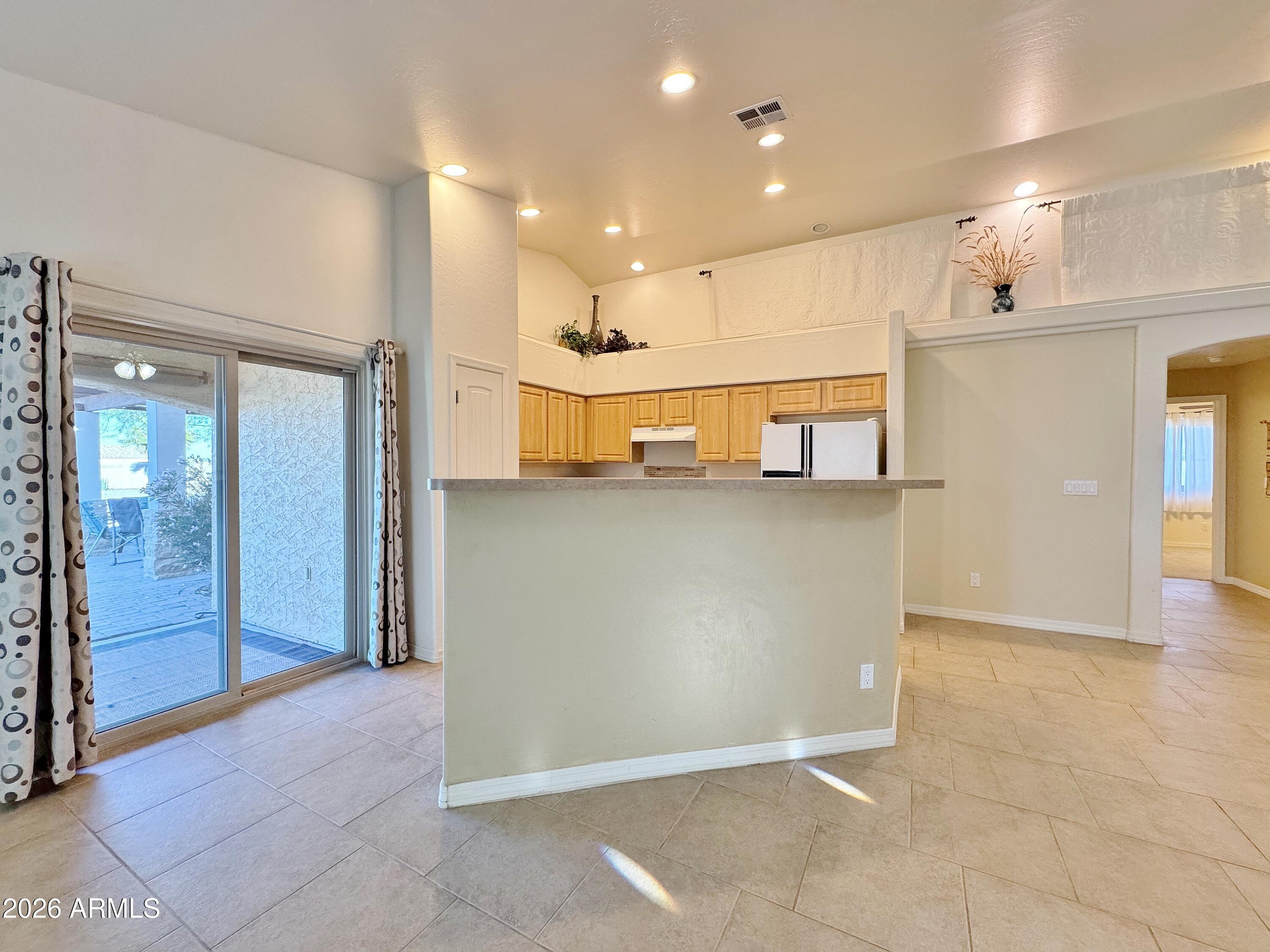 15774 South Saxon Road Arizona City, AZ 85123 - Photo 13 of 53 a view of a kitchen with a refrigerator and a sink