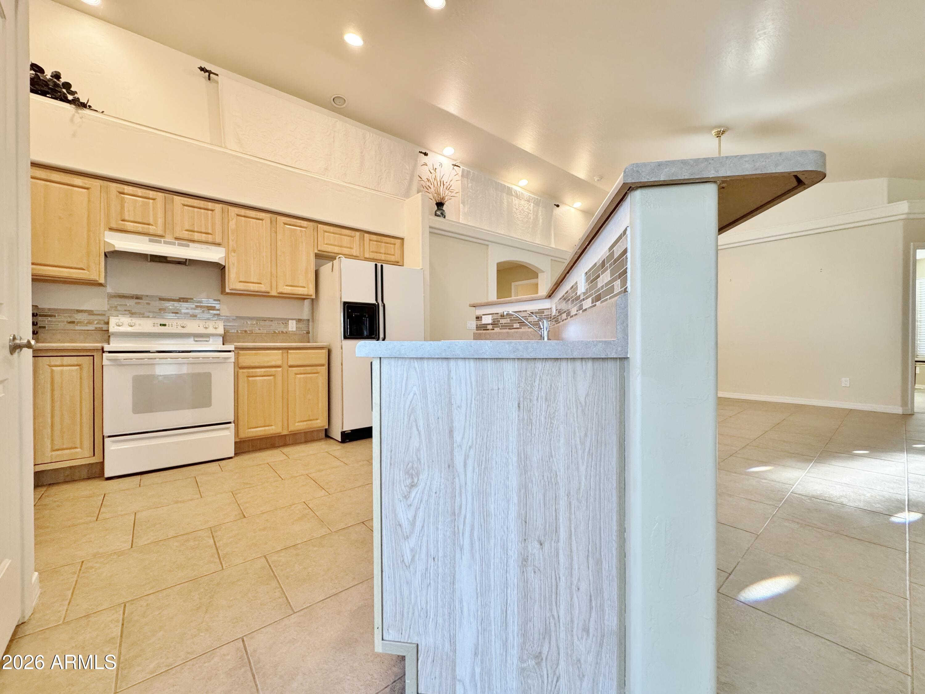 15774 South Saxon Road Arizona City, AZ 85123 - Photo 14 of 53 a view of a kitchen with wooden floor and electronic appliances