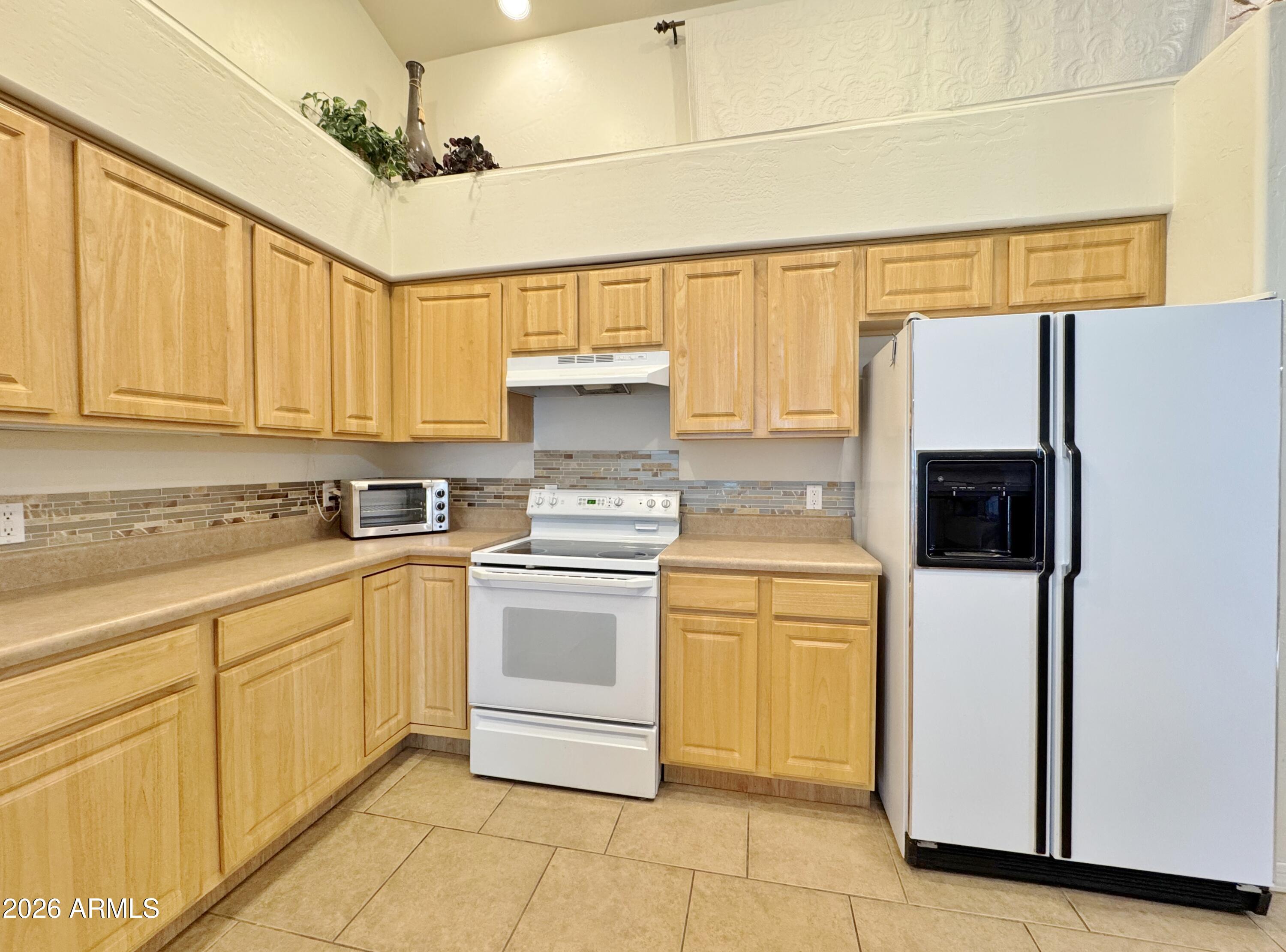 15774 South Saxon Road Arizona City, AZ 85123 - Photo 16 of 53 a kitchen with a refrigerator sink and cabinets